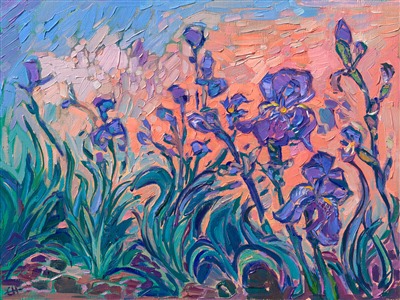 A cluster of purple irises bloom in the red earth of Sedona, Arizona. This painting captures the striking color contrasts of flowers in the desert. Short, expressive brushstrokes bring texture and movement to the piece.